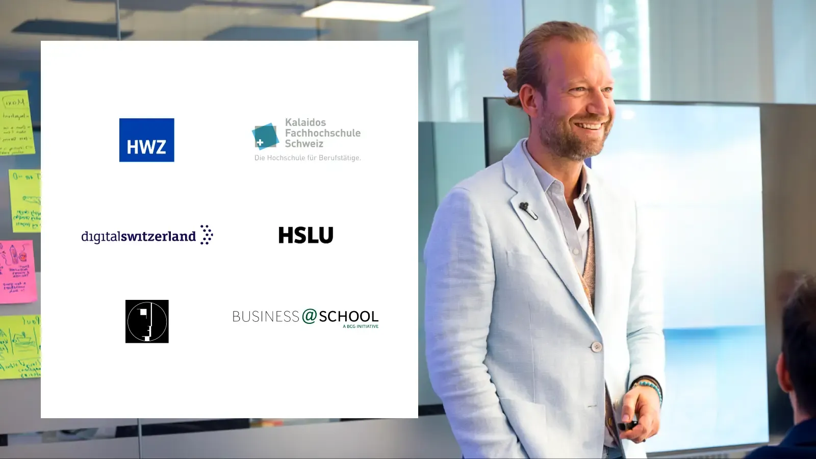 Smiling man in a light suit presents with multiple business and education logos displayed.