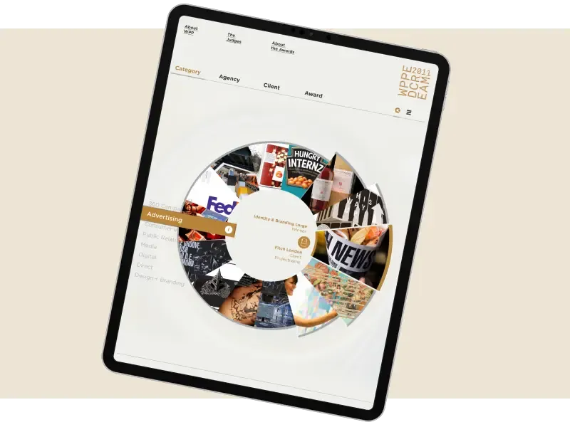 Tablet displaying a circular digital interface with various content categories and images.