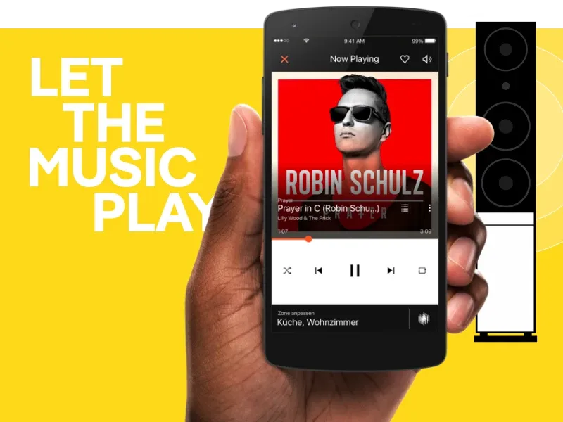 Hand holds smartphone playing Robin Schulz music, with a speaker and 'LET THE MUSIC PLAY'.